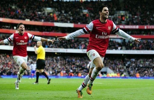 Arsenal's midfielder Mikel Arteta (R) celebrates scoring